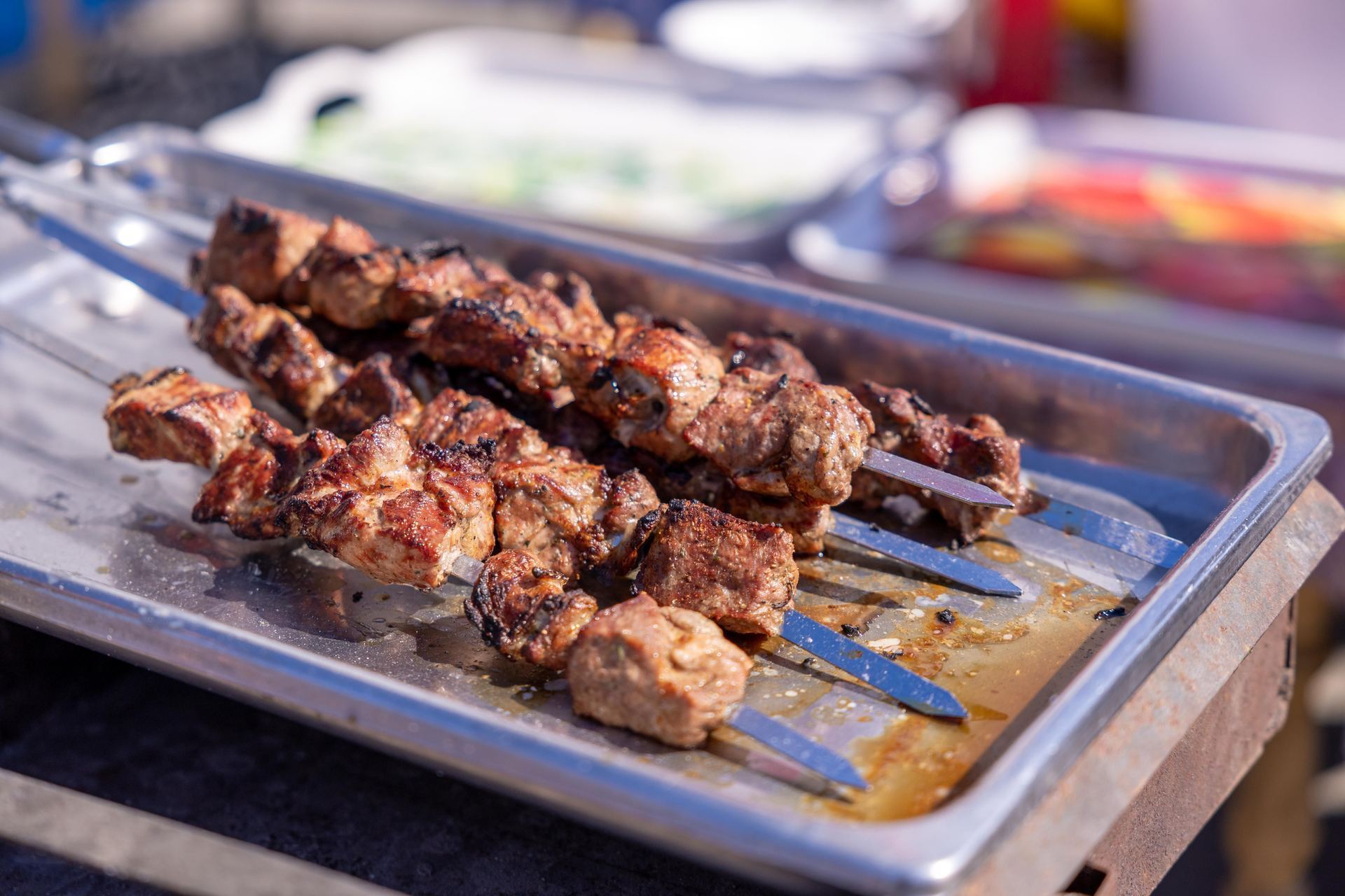 Fresh kababs cooking over a charcoal grill